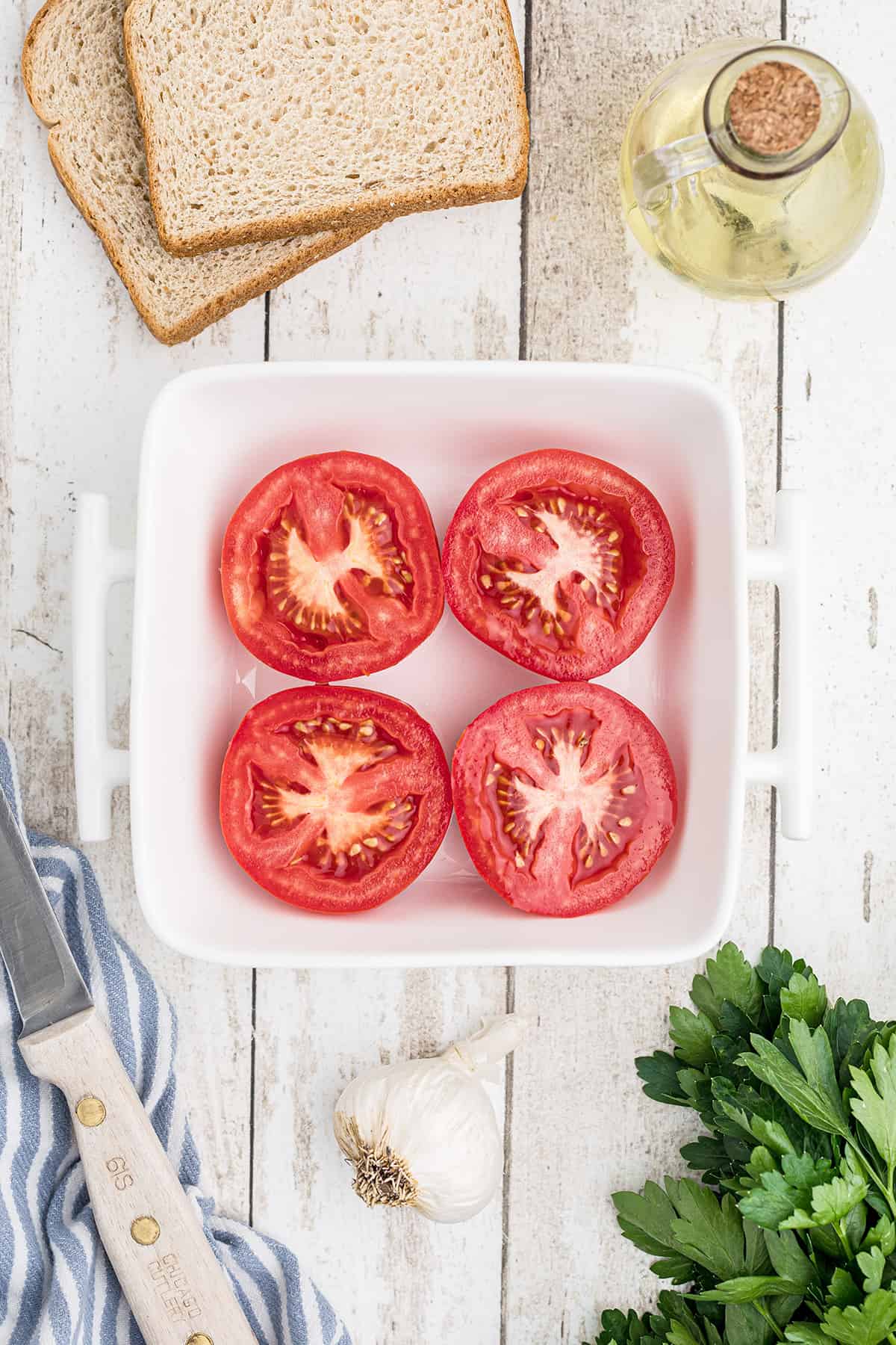 Halved tomatoes in a baking dish.