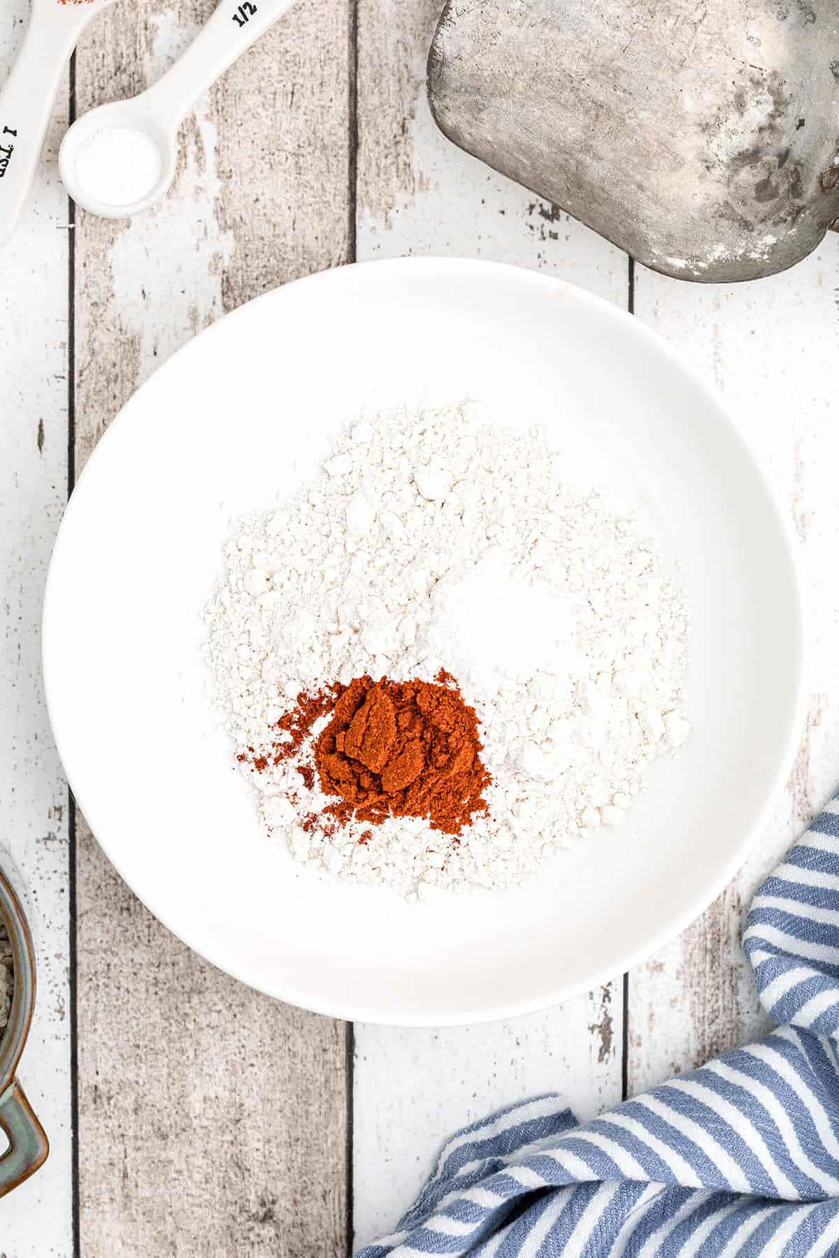 White bowl with flour and spices.