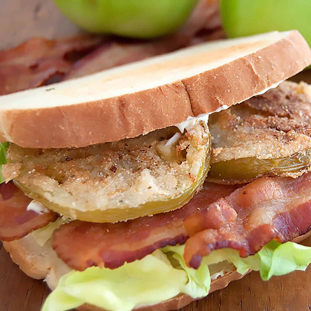 Fried green tomato BLT on a serving board.