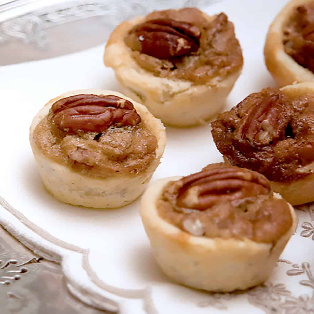 Pecan tassies on a linen napkin.