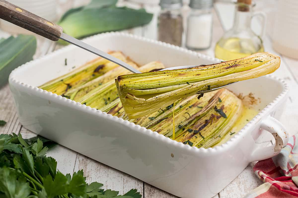 Roasted leeks in a baking dish.