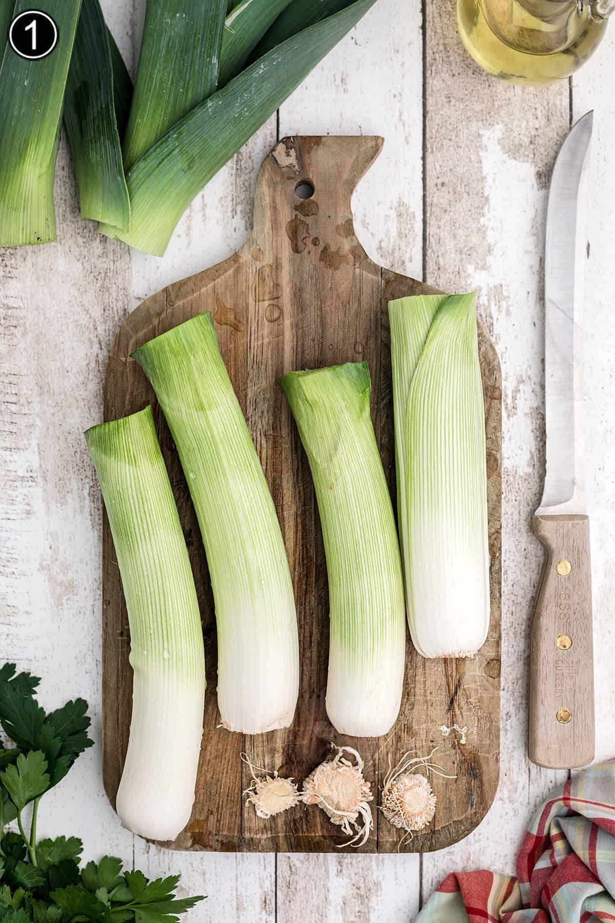 Cleaned leeks on a cutting board.