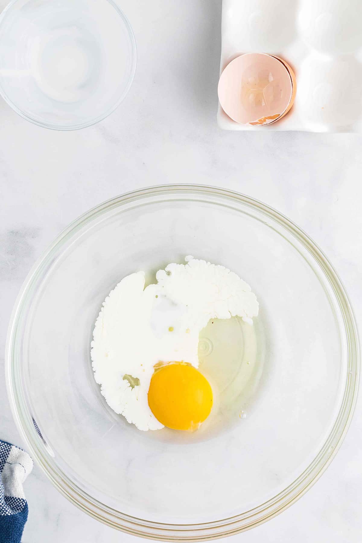 Egg and cream in a mixing bowl.