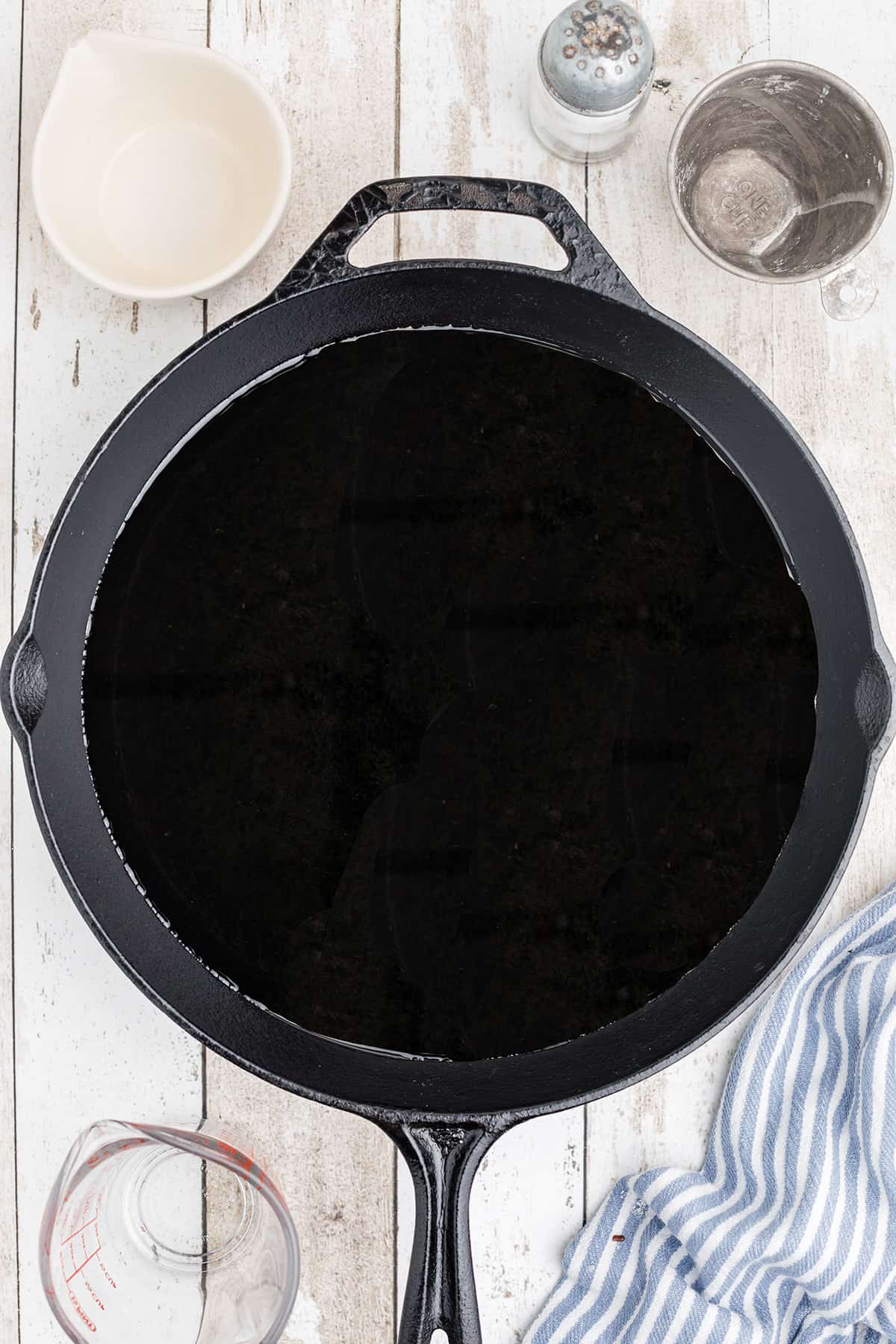 Cast iron skillet with oil in the bottom.