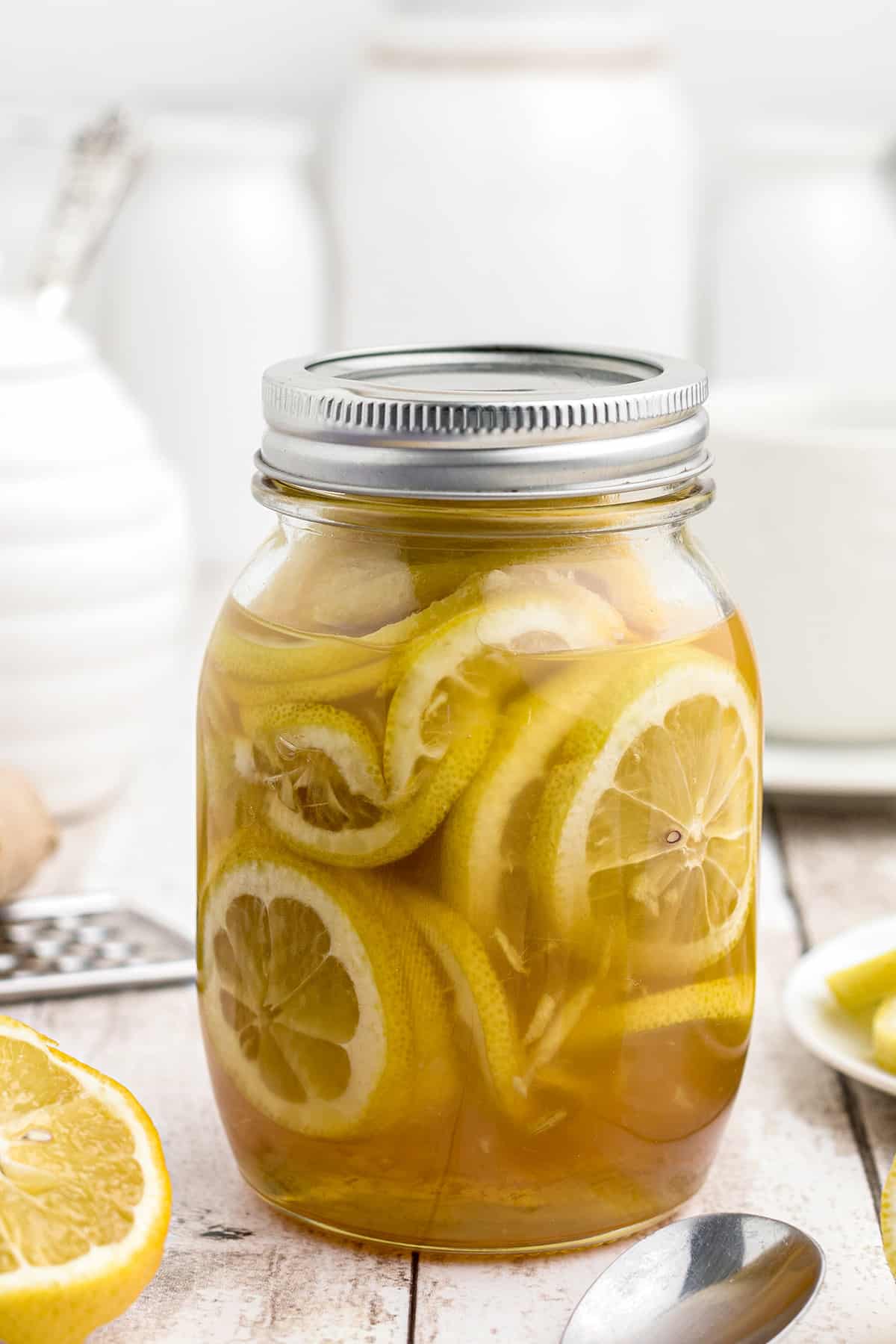 A mixture of lemon, honey, and ginger in a mason jar.