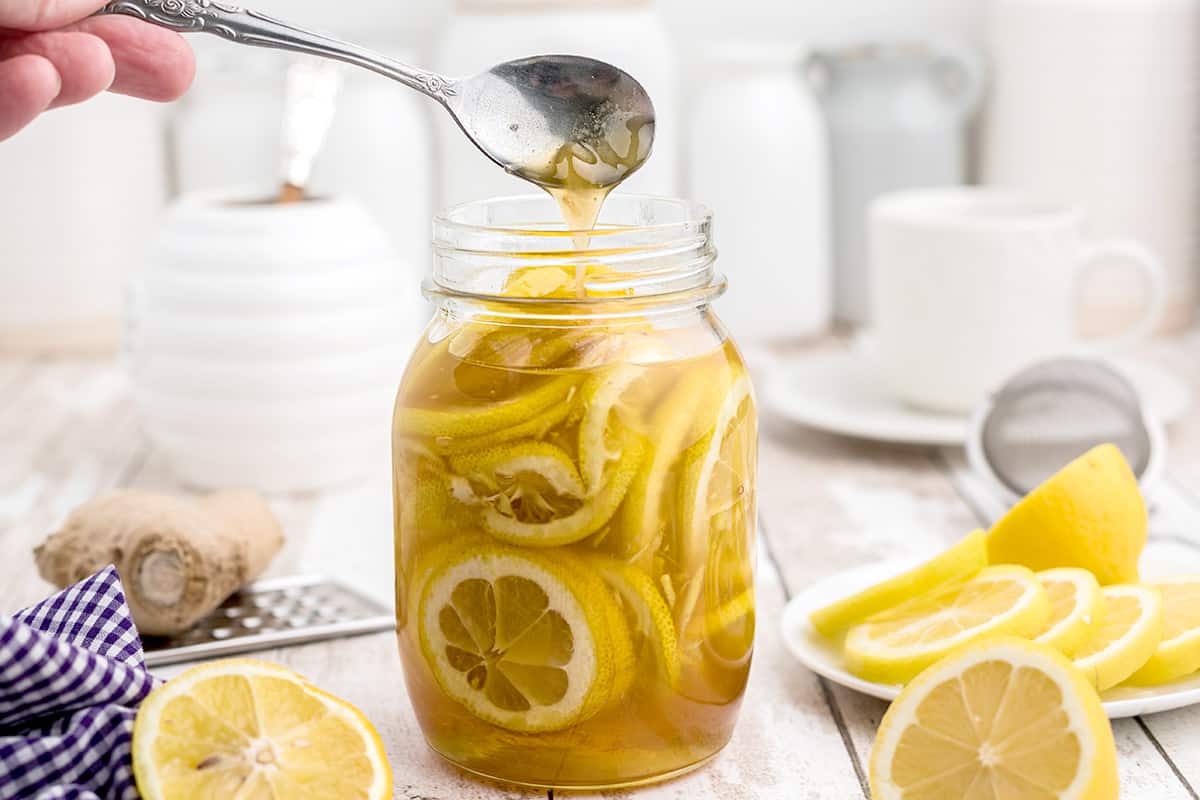 A mixture of lemon, honey, and ginger in a mason jar.