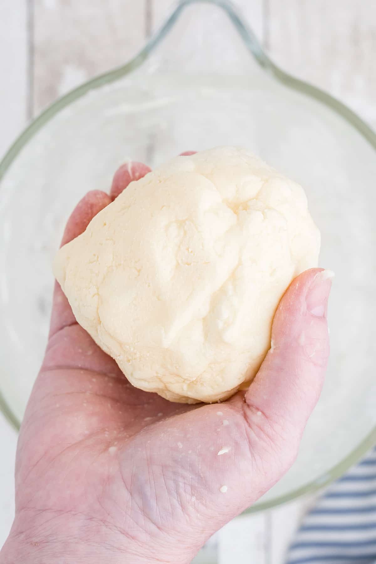 A lump of washed butter held in the cook's hand.