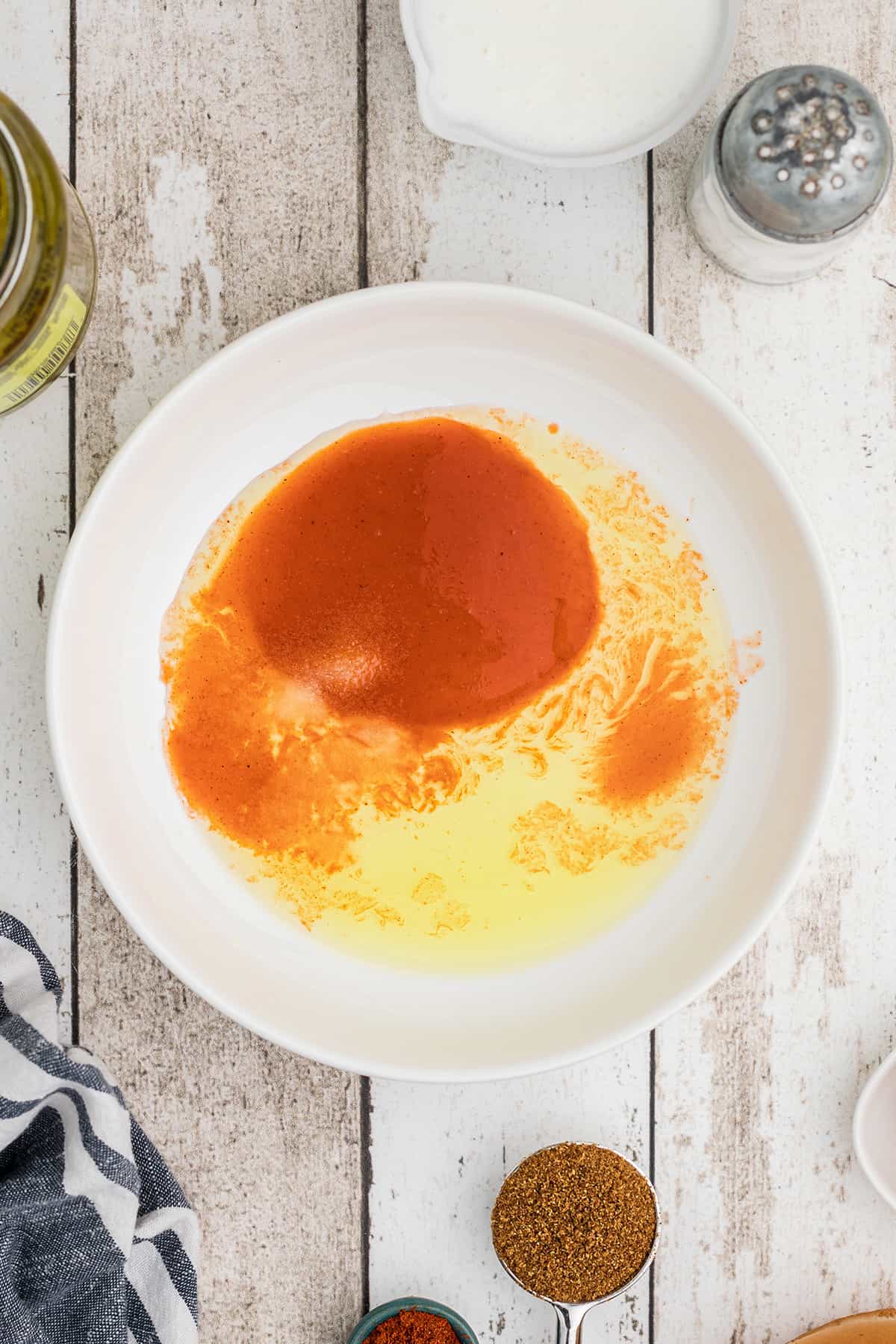 Pickle juice, hot sauce, and salt in a shallow bowl.