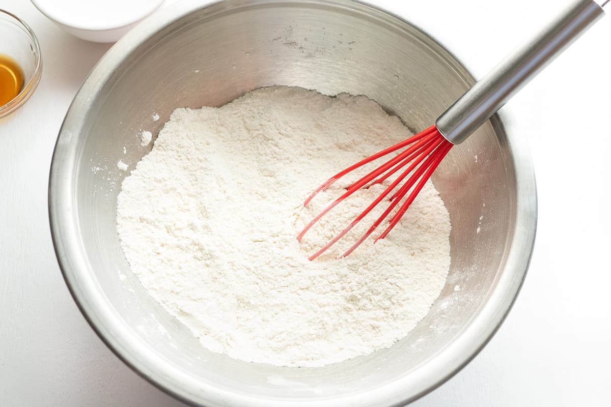Dry ingredients being whisked in a bowl.