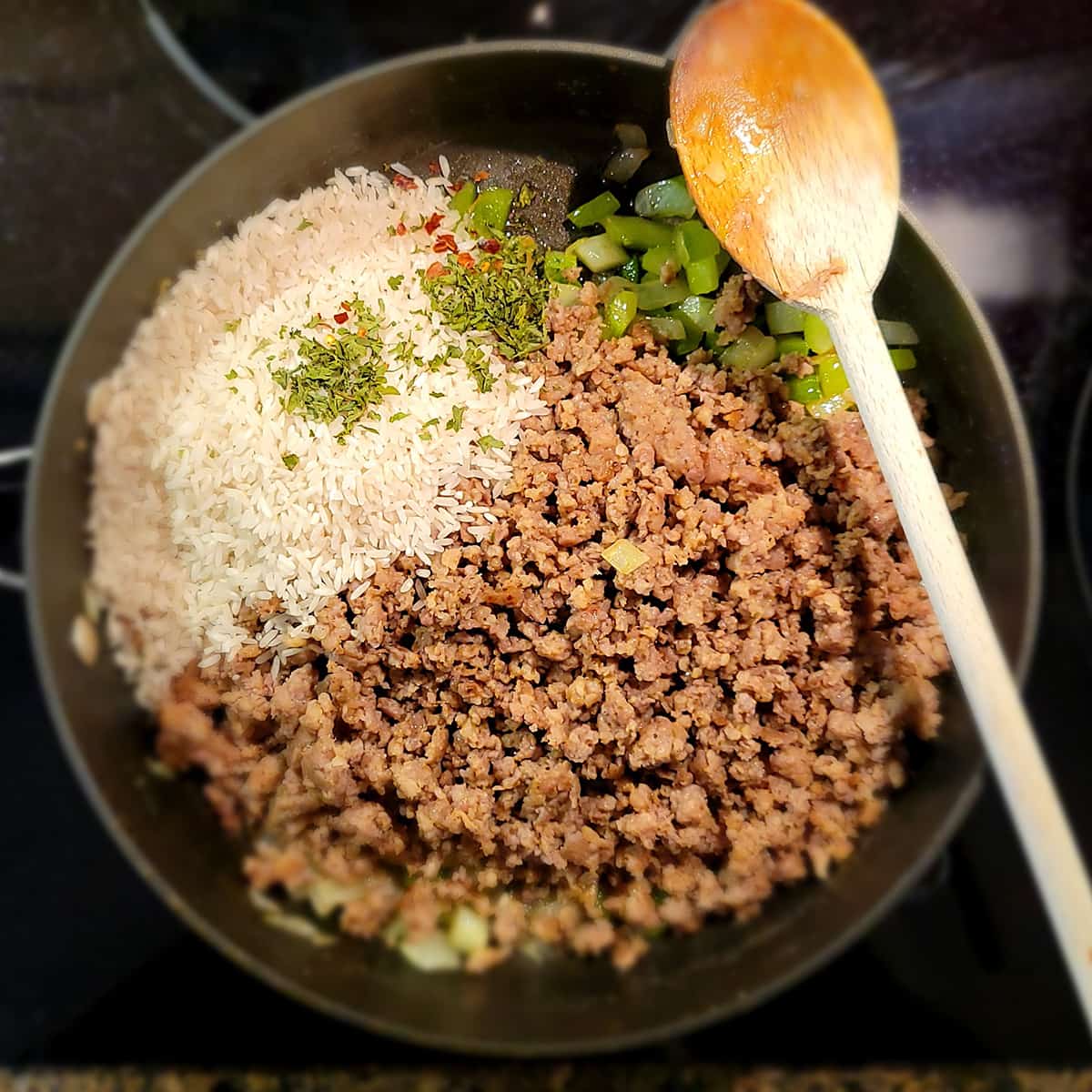 Rice and seasonings added to skillet.
