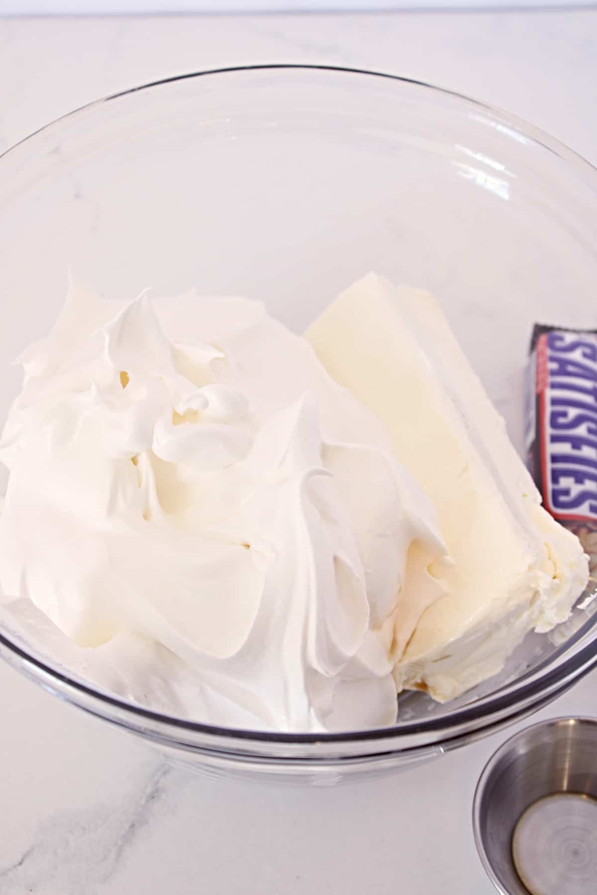 Cream cheese, whipped topping, and vanilla in a mixing bowl.