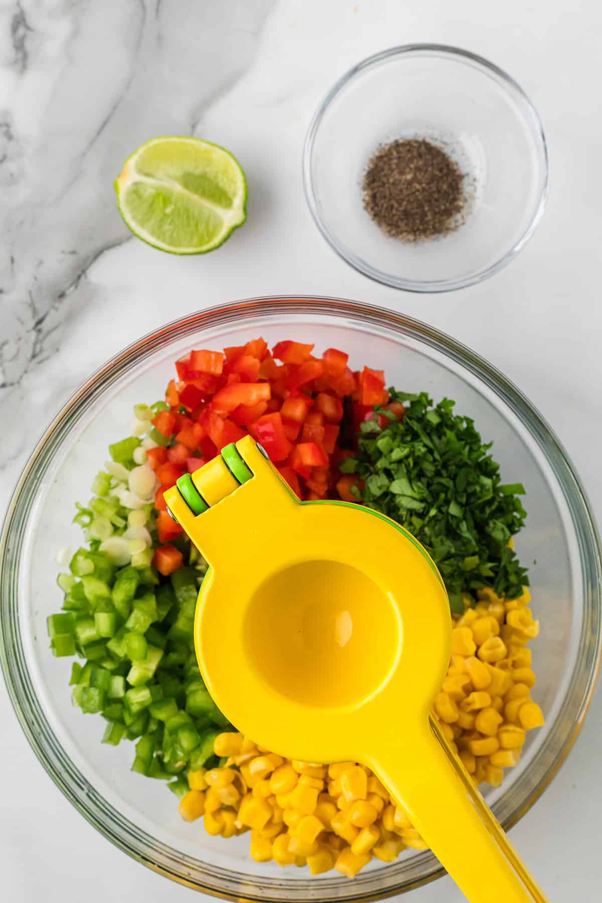Squeezing lime juice into the mixture.