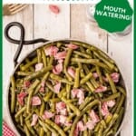 Green Beans with ham hocks in a serving dish on a tabletop. Text overlay for pinning.