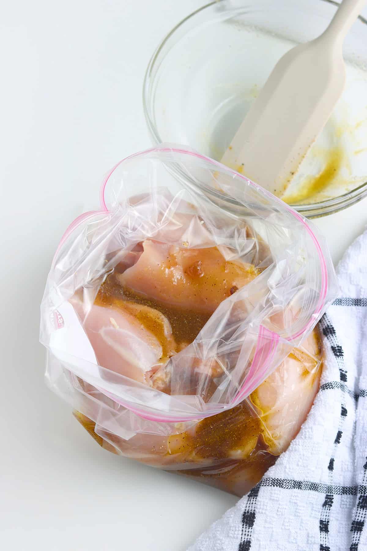 Marinade and chicken thighs in a zip top bag.