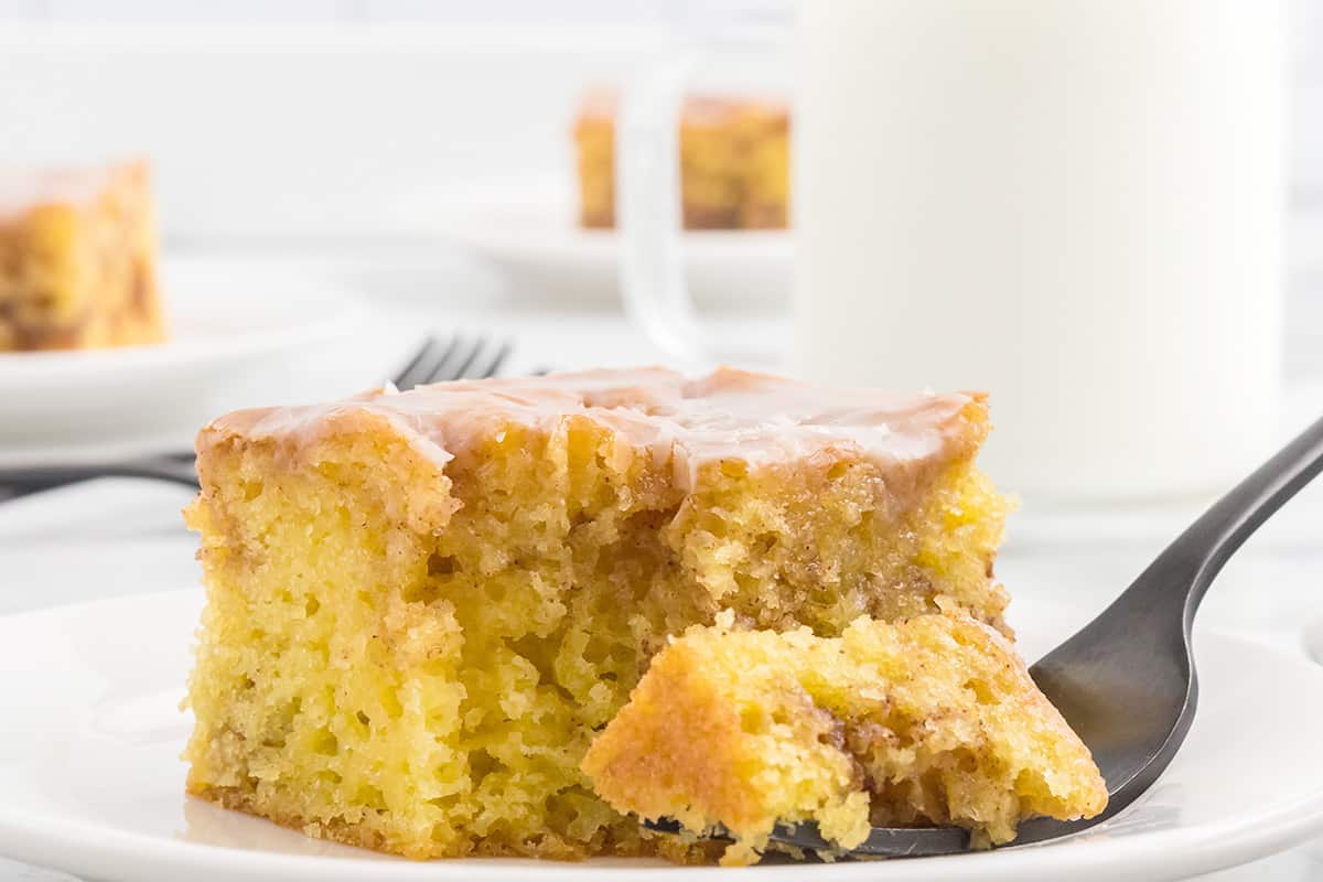 A serving of homemade honey bun cake on a white plate.