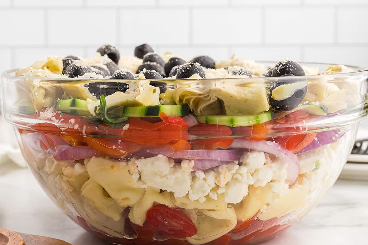 Finished salad layered in a glass bowl.