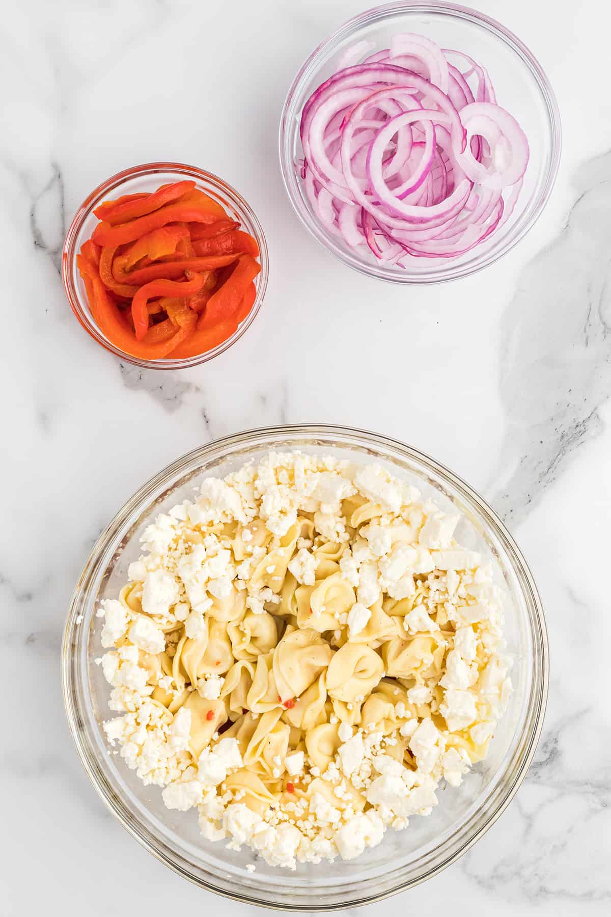 Feta cheese added to tortellini salad.