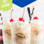 Three classic Coke floats topped with whipped cream and cherries are served in tall glasses with striped straws. A Coca-Cola bottle is visible in the background.