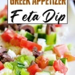 A close-up of a Greek appetizer feta dip with chopped tomatoes, green onions, olives, and feta cheese on a white plate. Text overlay reads My Big Fat Greek Appetizer Feta Dip.