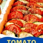 A baked dish of sliced tomatoes and zucchini arranged in rows in a white baking dish, seasoned with herbs.