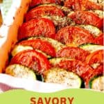 A baked dish of sliced tomatoes and zucchini arranged in layers, seasoned with herbs, in a white baking dish. Text overlay reads: Savory Tomato & Zucchini Tian.