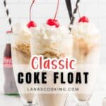 Three tall glasses of Coke float topped with whipped cream and cherries, each with a straw. A bottle of Coca-Cola is in the background. Text overlay reads Classic Coke Float.