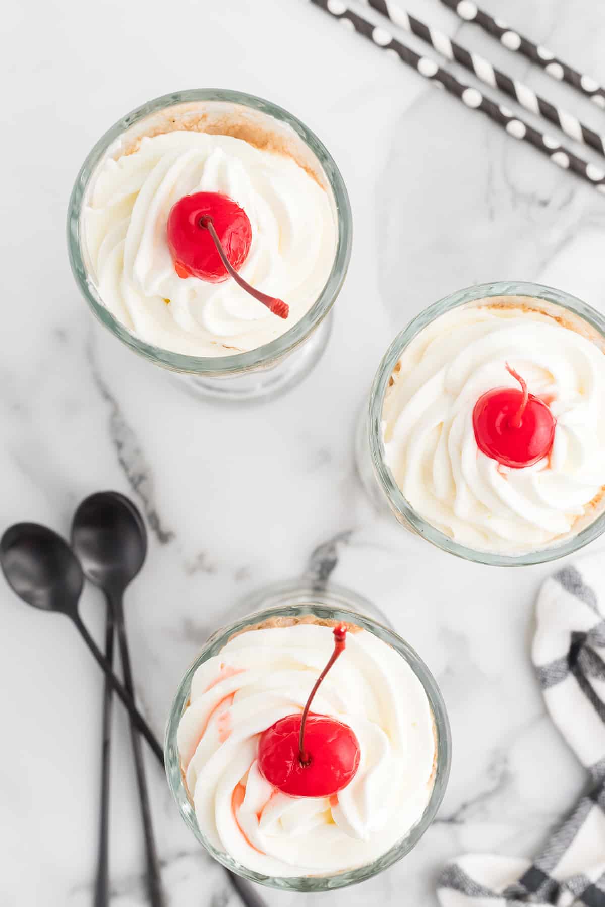 Floats topped with whipped cream and cherries.