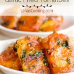 Garlic fried tomatoes in a small white serving bowl.