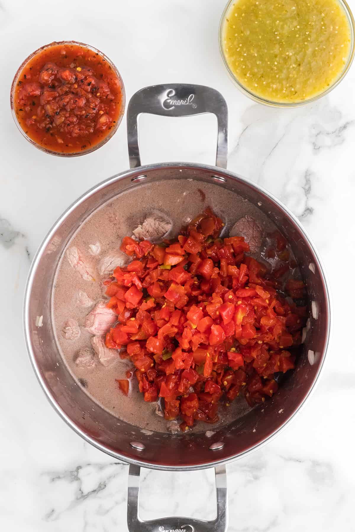 Adding ingredients to the stew.