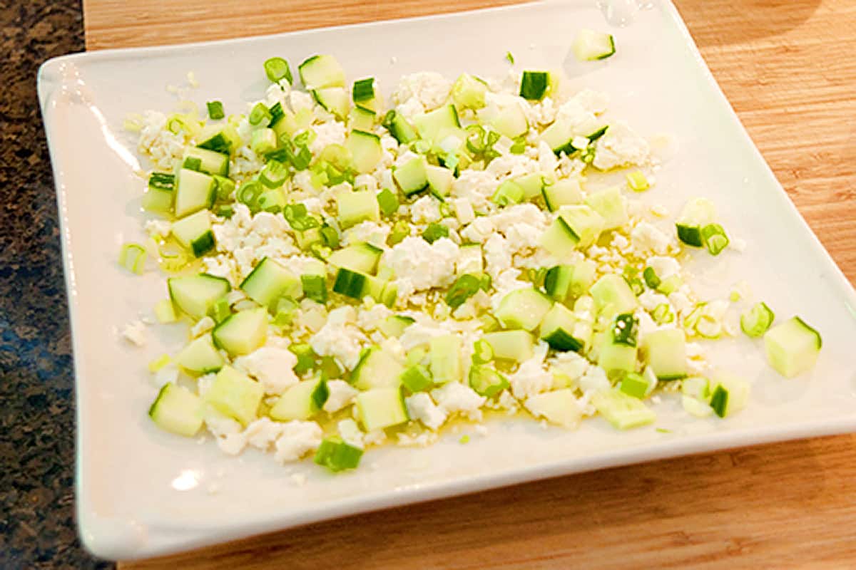Cucumber and onions added to feta and olive oil.