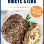 A grilled ribeye steak served on a plate with a loaded baked potato, garnished with parsley. Text reads The Perfect Grilled Ribeye Steak and Cooking Temps Explained.