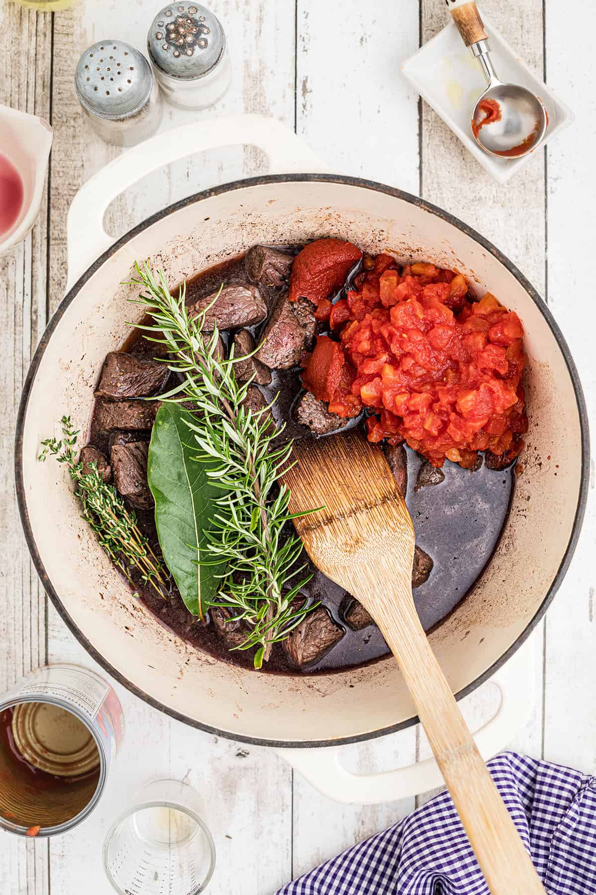 Tomatoes and herbs added to the stew.