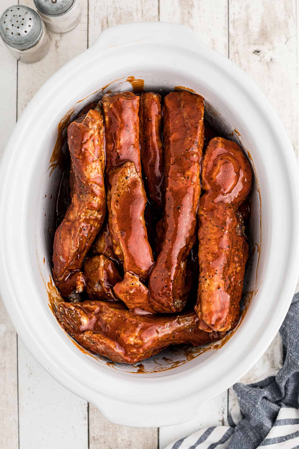 All ribs and sauce layered in the crockpot.