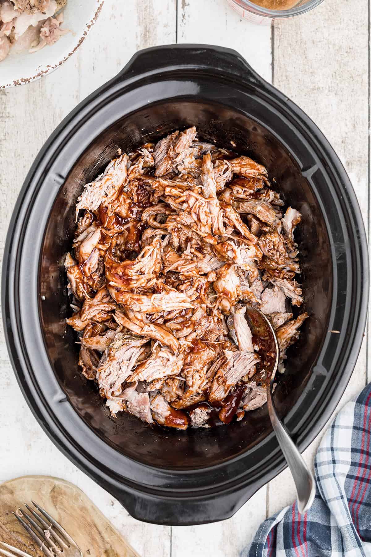 Sauce and juices stirred into the shredded pork.