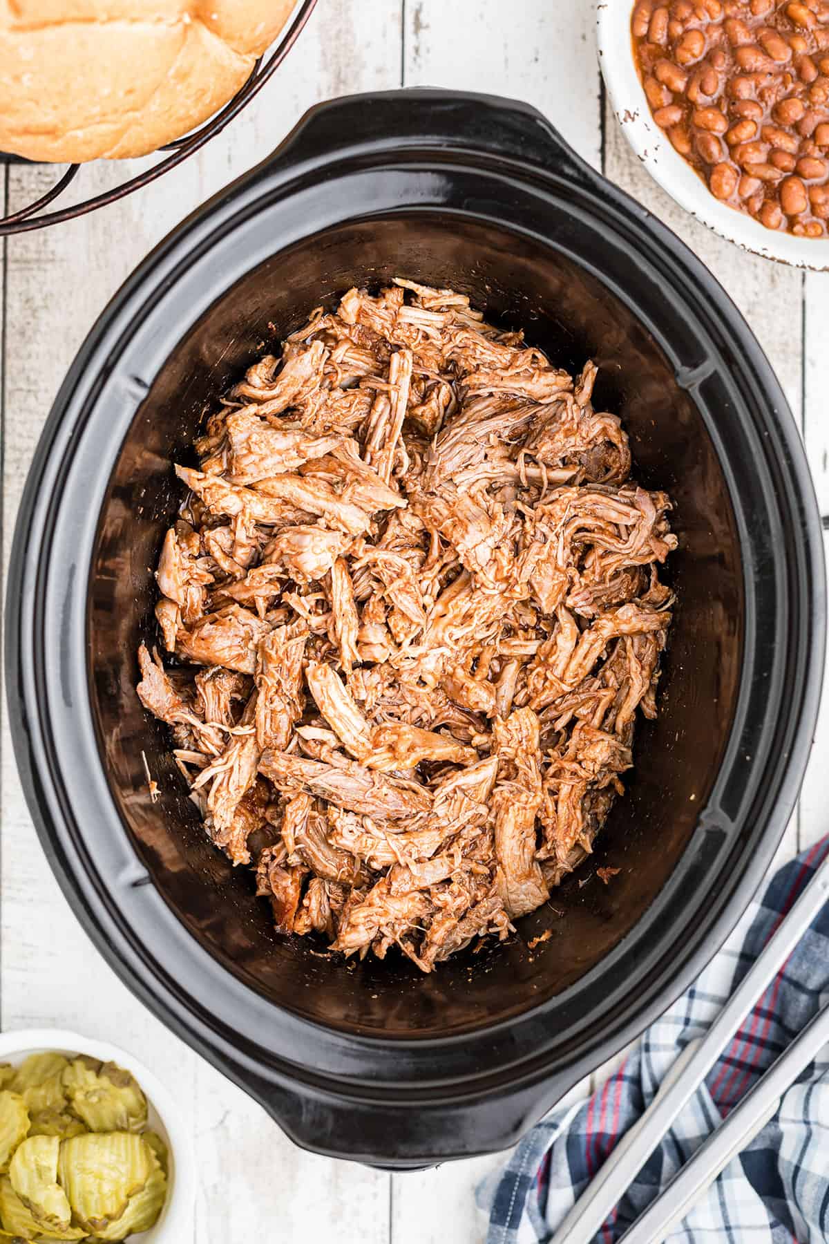 Finished pulled pork in a slow cooker.