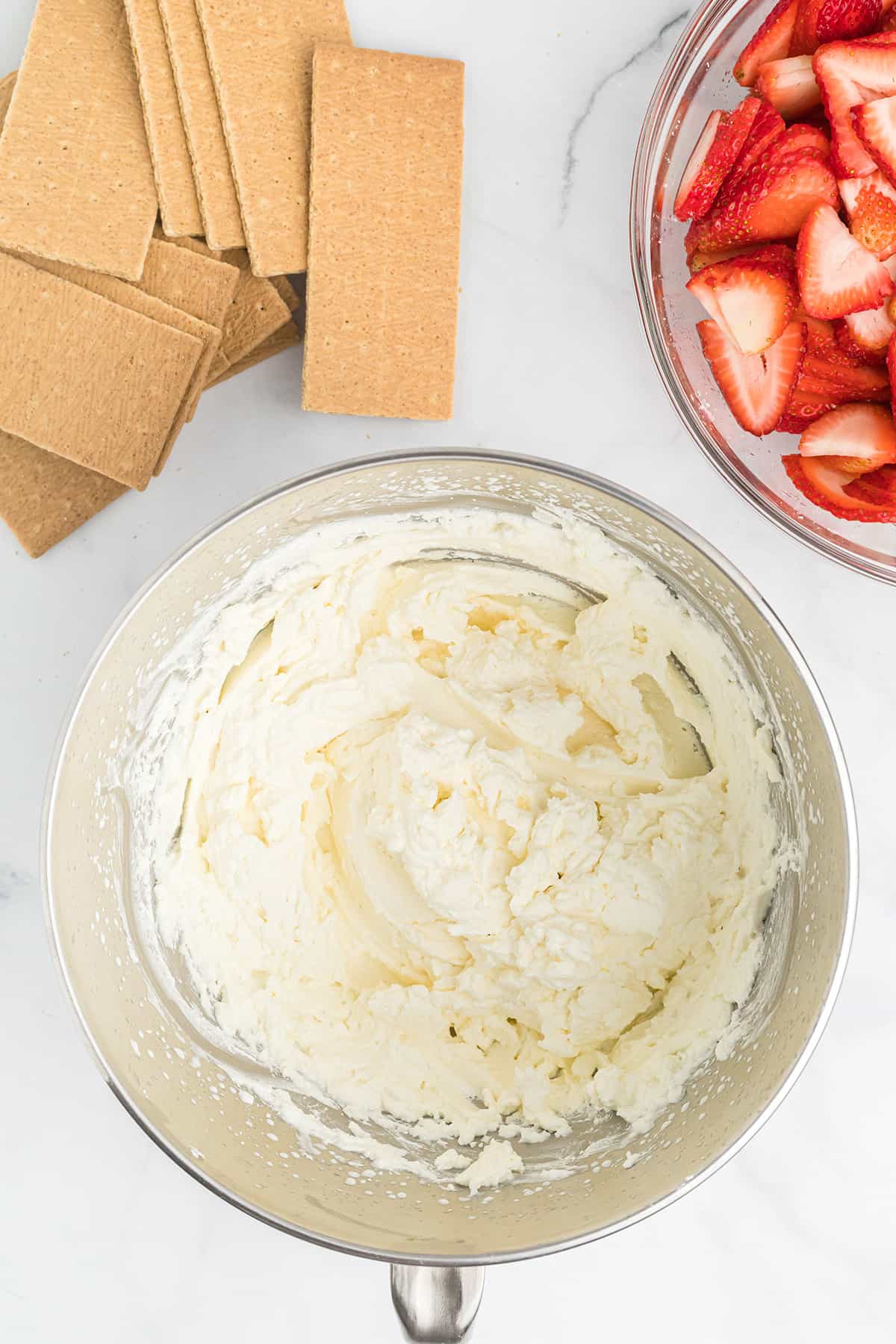 Finished whipped cream in a mixing bowl.