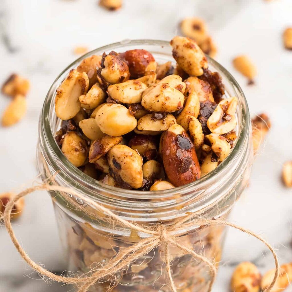 Finished peanuts in a mason jar with string tied around the top.