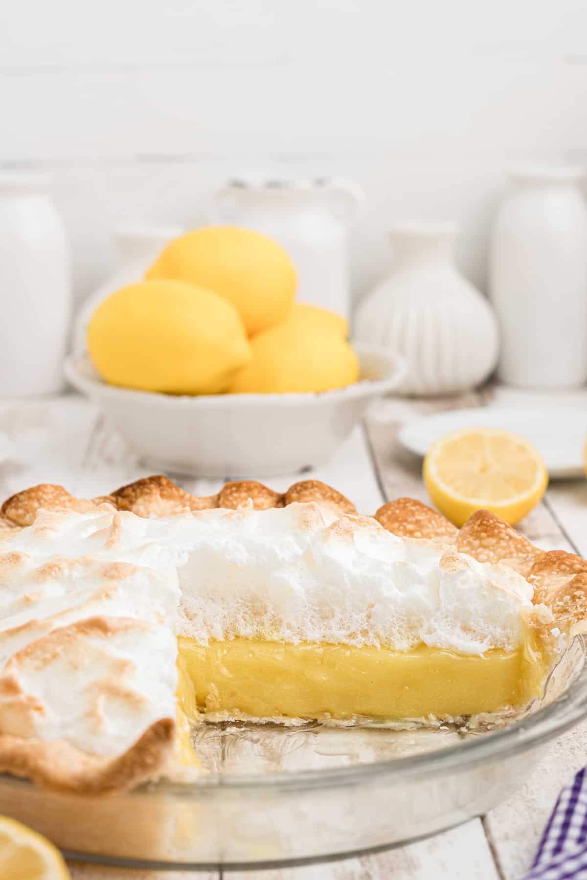 Cutaway shot of lemon meringue pie showing layers of meringue and filling.