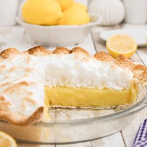 Cutaway shot of lemon meringue pie showing layers of meringue and filling.