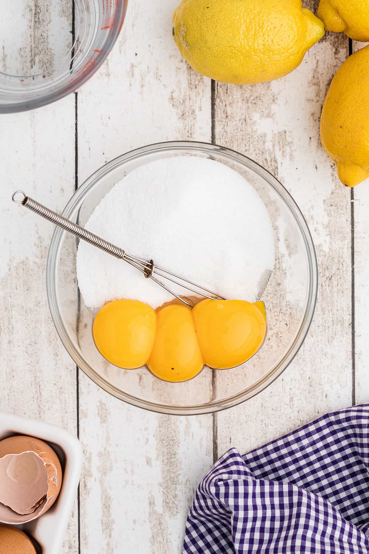 Egg yolks and sugar in a small bowl.