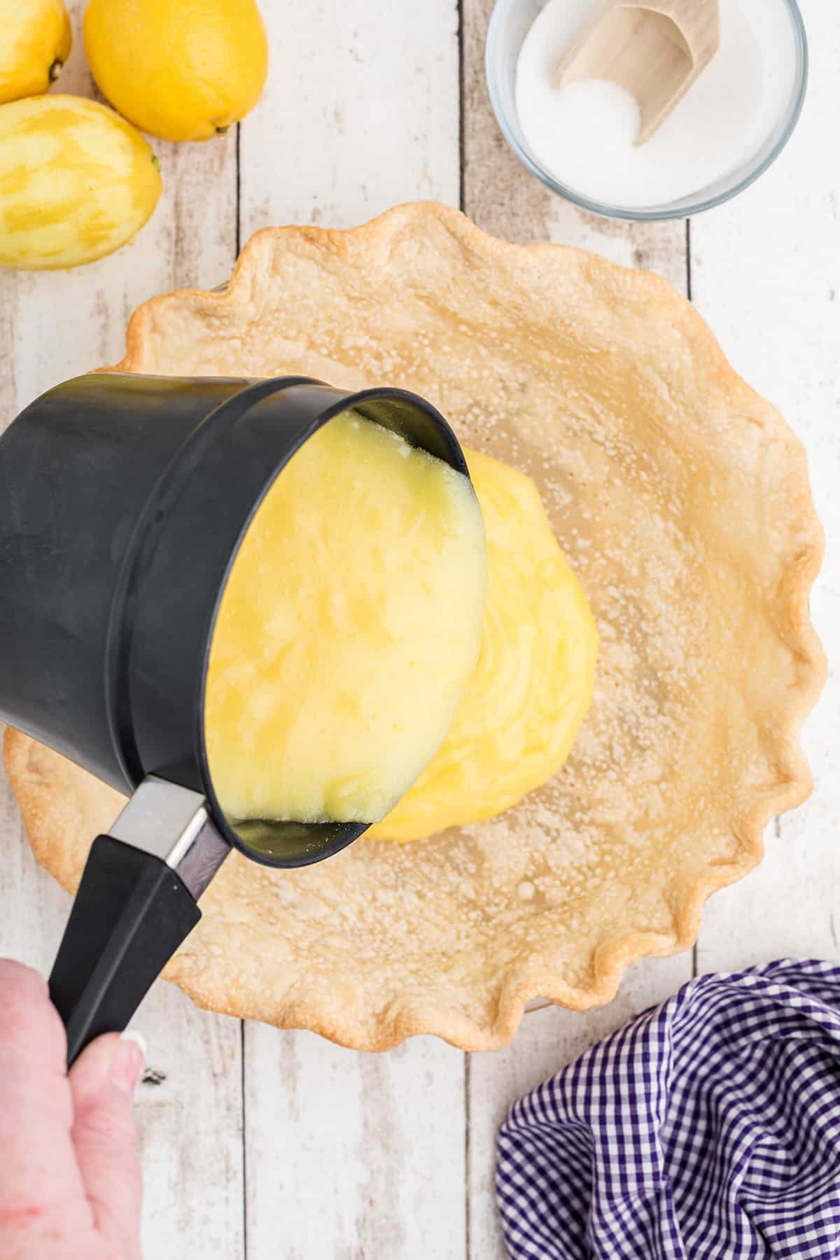 Pouring pie filling into the crust.