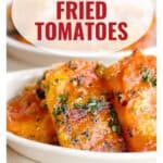 Close-up of garlic fried tomatoes on a plate, with a website link and text reading Garlic Fried Tomatoes.