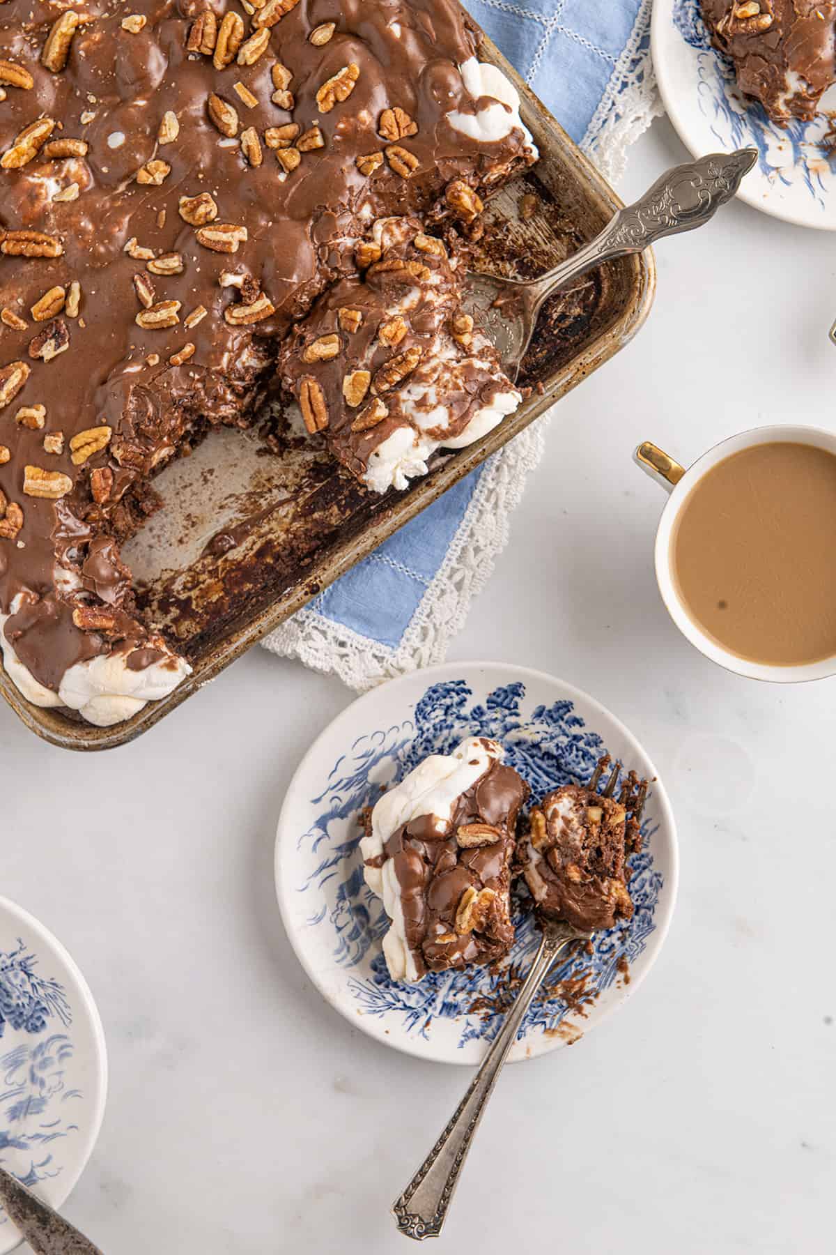 A slice of cake with a cup of coffee.