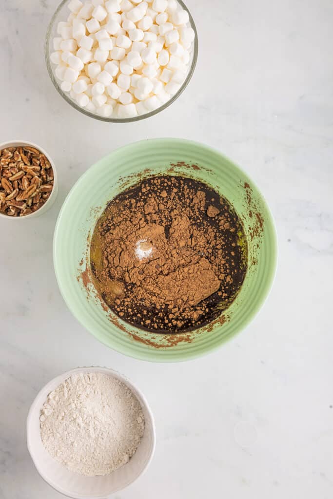 Sugar, butter, cocoa, eggs, vanilla and salt in a mixing bowl.