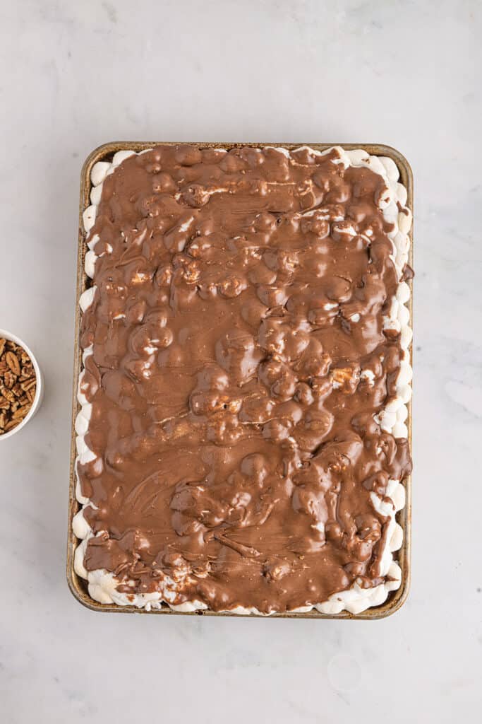 Frosting applied to top of warm cake.