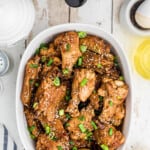 Finished wings in a white serving dish.