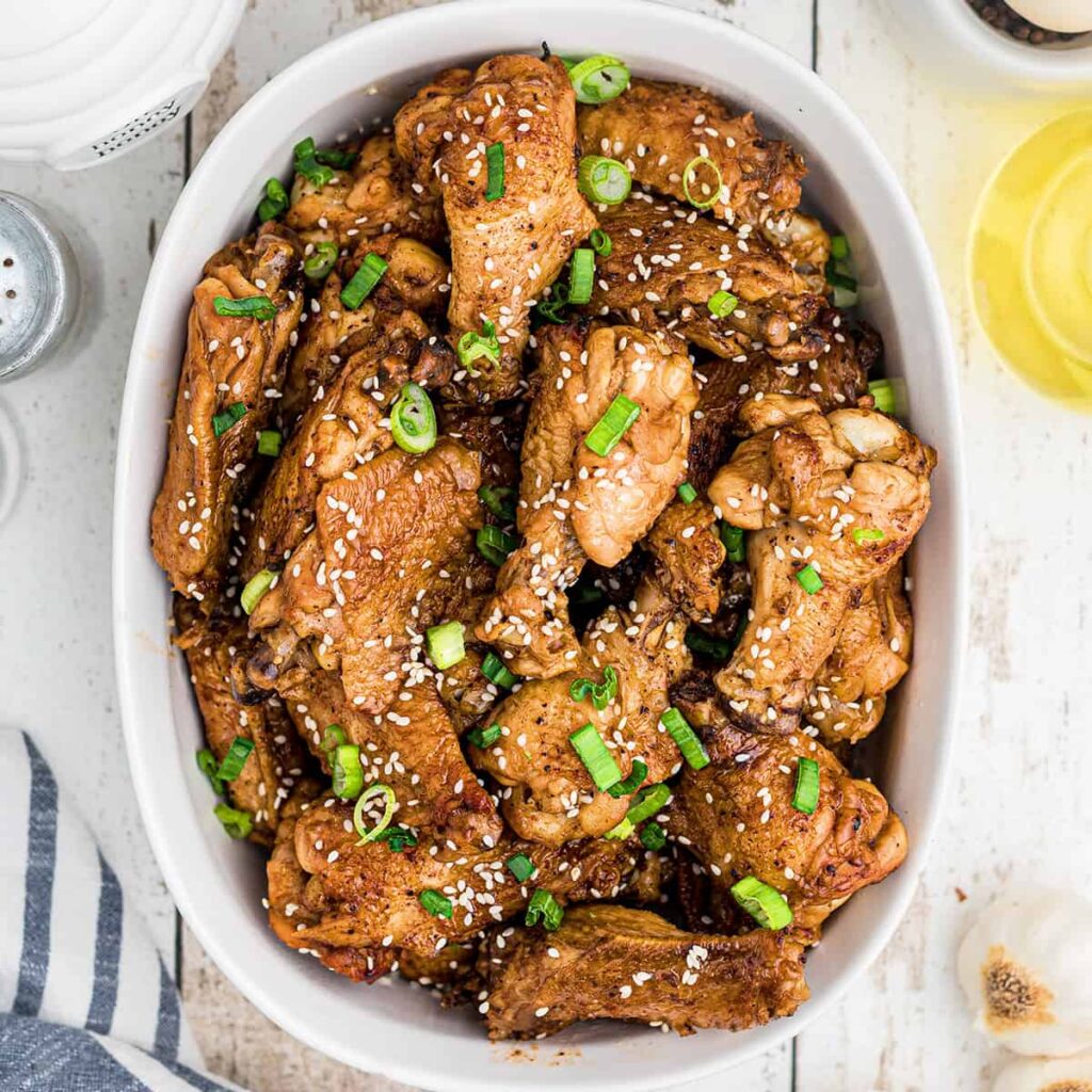 Finished wings in a white serving dish.