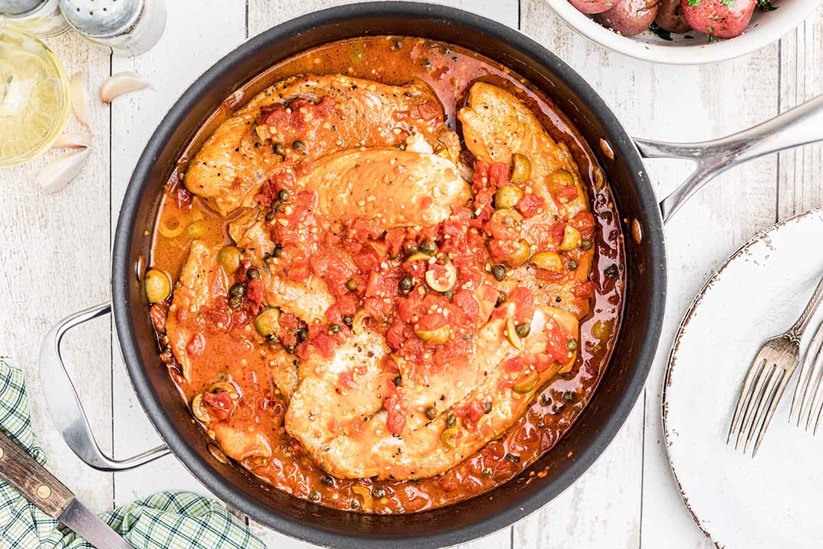 Cooked fish in a rich tomato and olive sauce.