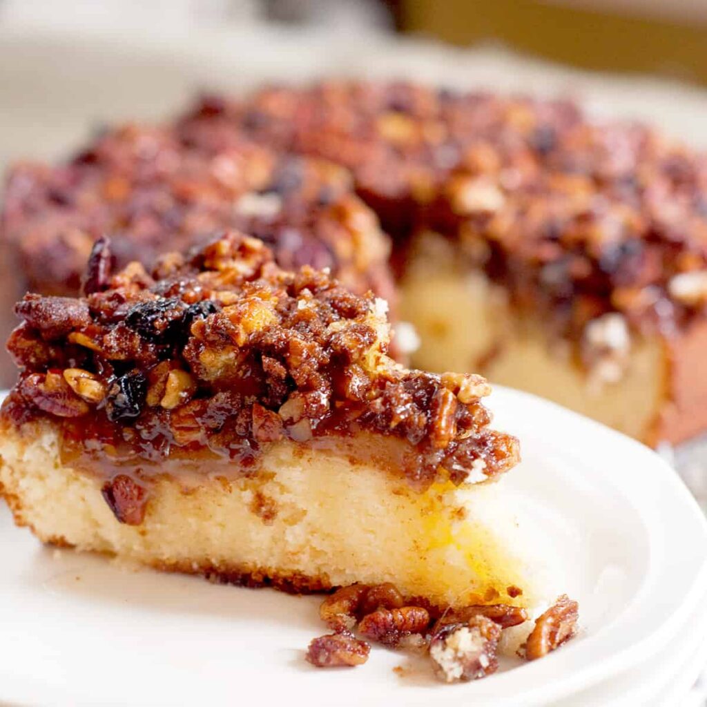 A slice of coffee cake on a white plate.