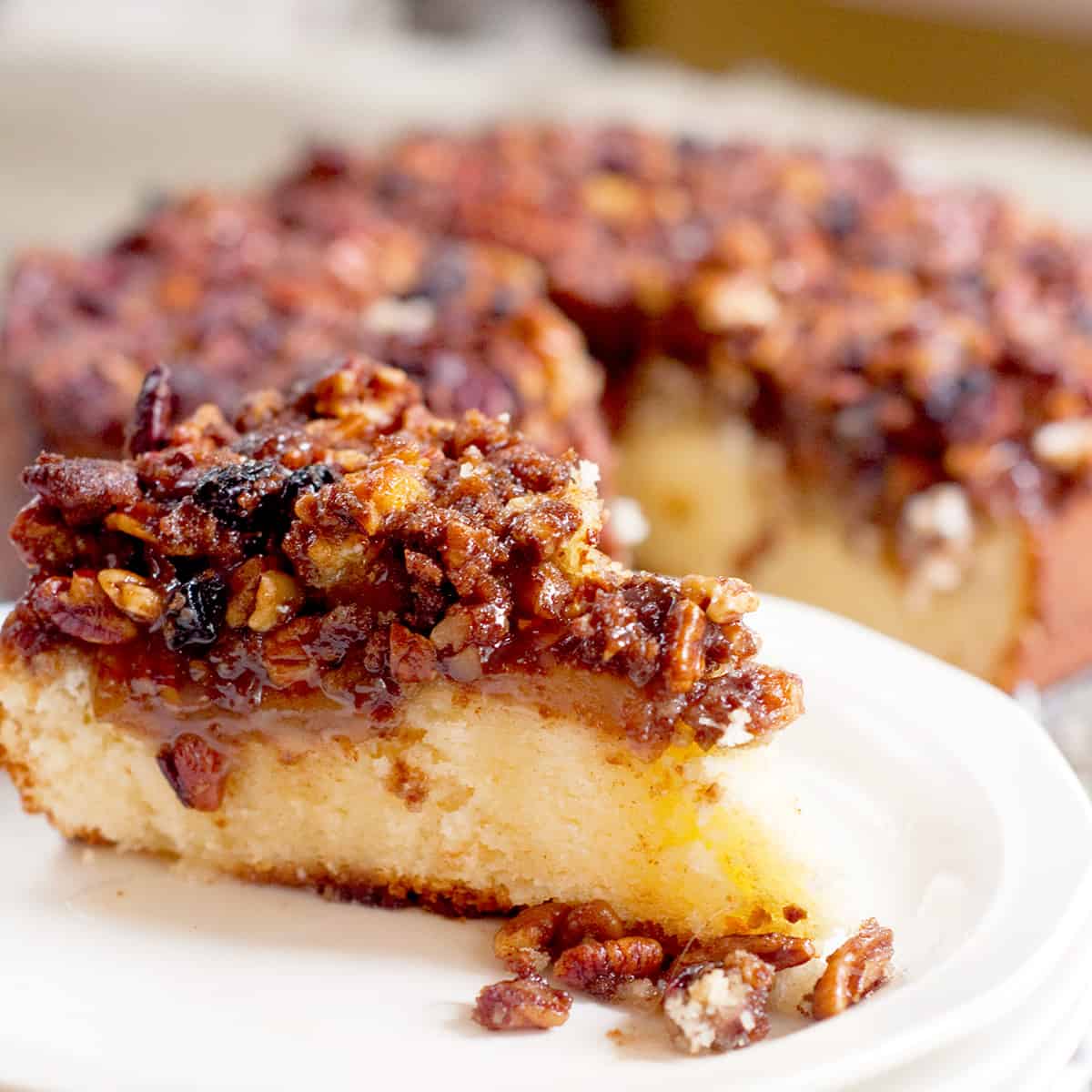 A slice of coffee cake on a white plate.